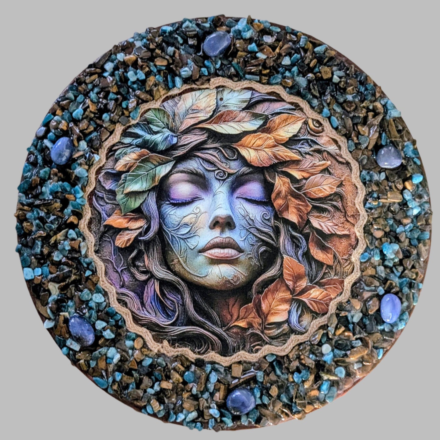 "Autumn magic captured in a handmade canvas with earthy stones, golden leaves, and a print of mystical woodland scene."
