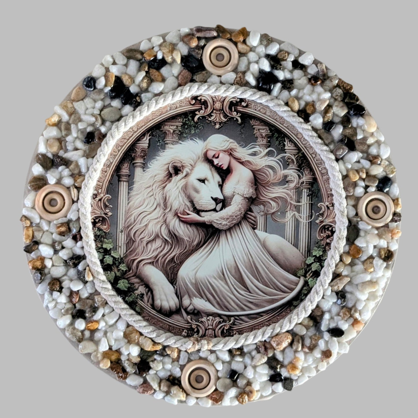 "The Lioness Touch" is a handmade canvas featuring a print of a white lion and lady in a tender embrace, framed by earthy stones and wooden accents.