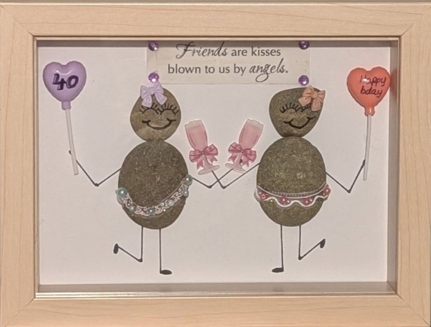 "Elegant pebble art celebrating a woman’s 40th birthday, featuring dancing figures with balloons and champagne, framed in woodgrain."