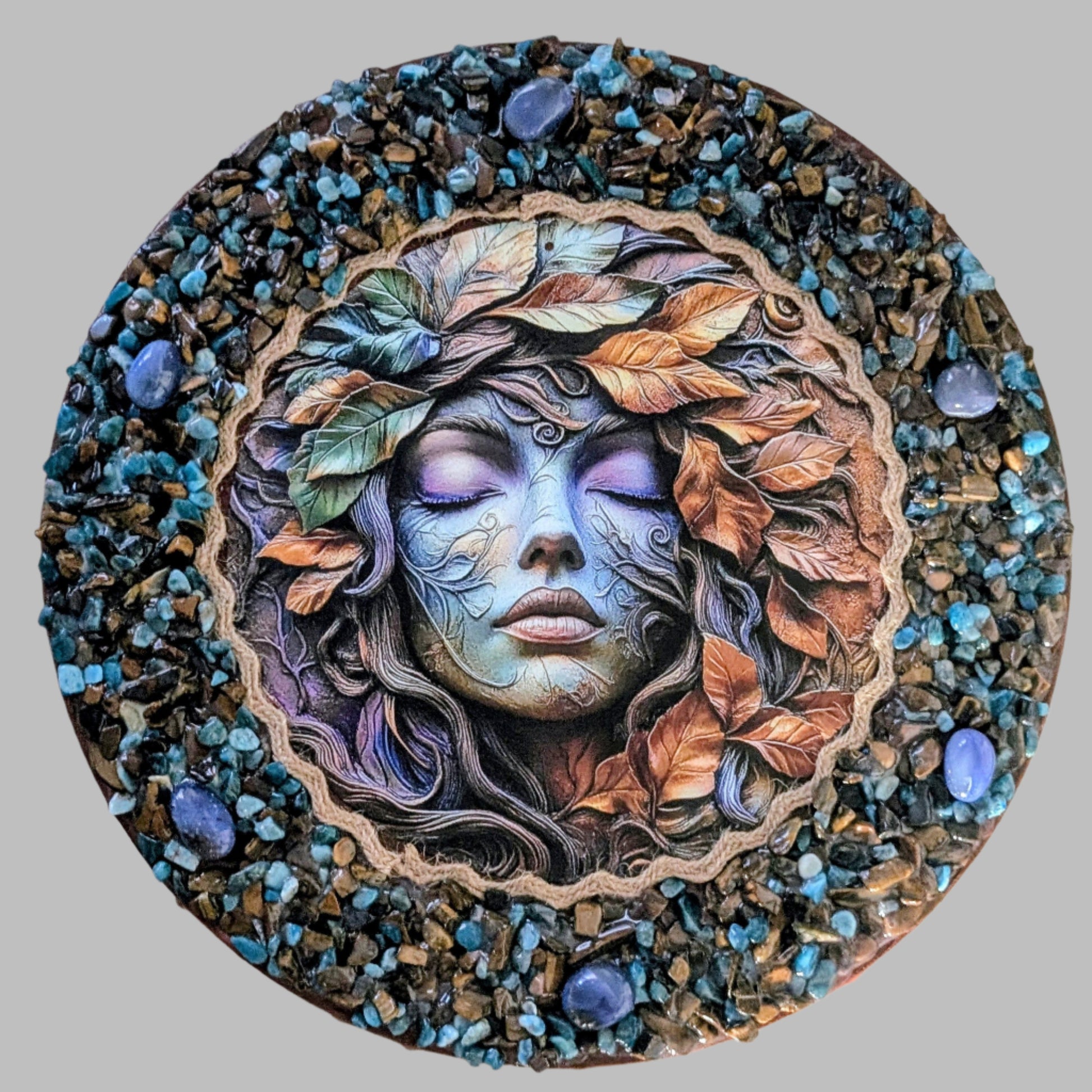 "Autumn magic captured in a handmade canvas with earthy stones, golden leaves, and a print of mystical woodland scene."