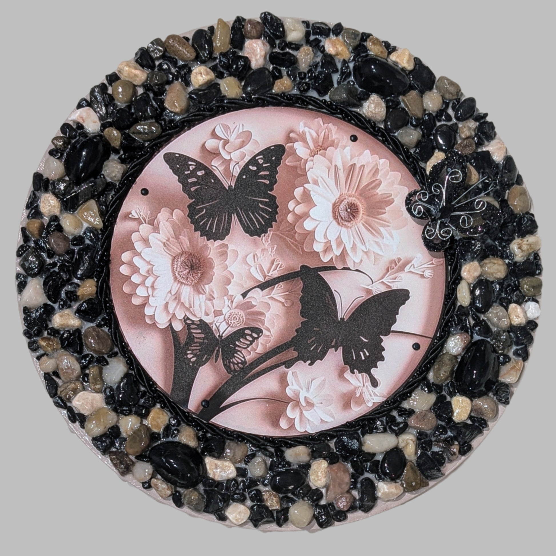 Handmade canvas with a print of 3 black butterflies, cream flowers, beaded black cord, earthy stones, and a black mesh butterfly, adding elegance and texture to any space.
