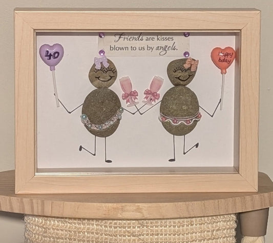 "Elegant pebble art celebrating a woman’s 40th birthday, featuring dancing figures with balloons and champagne, framed in woodgrain."