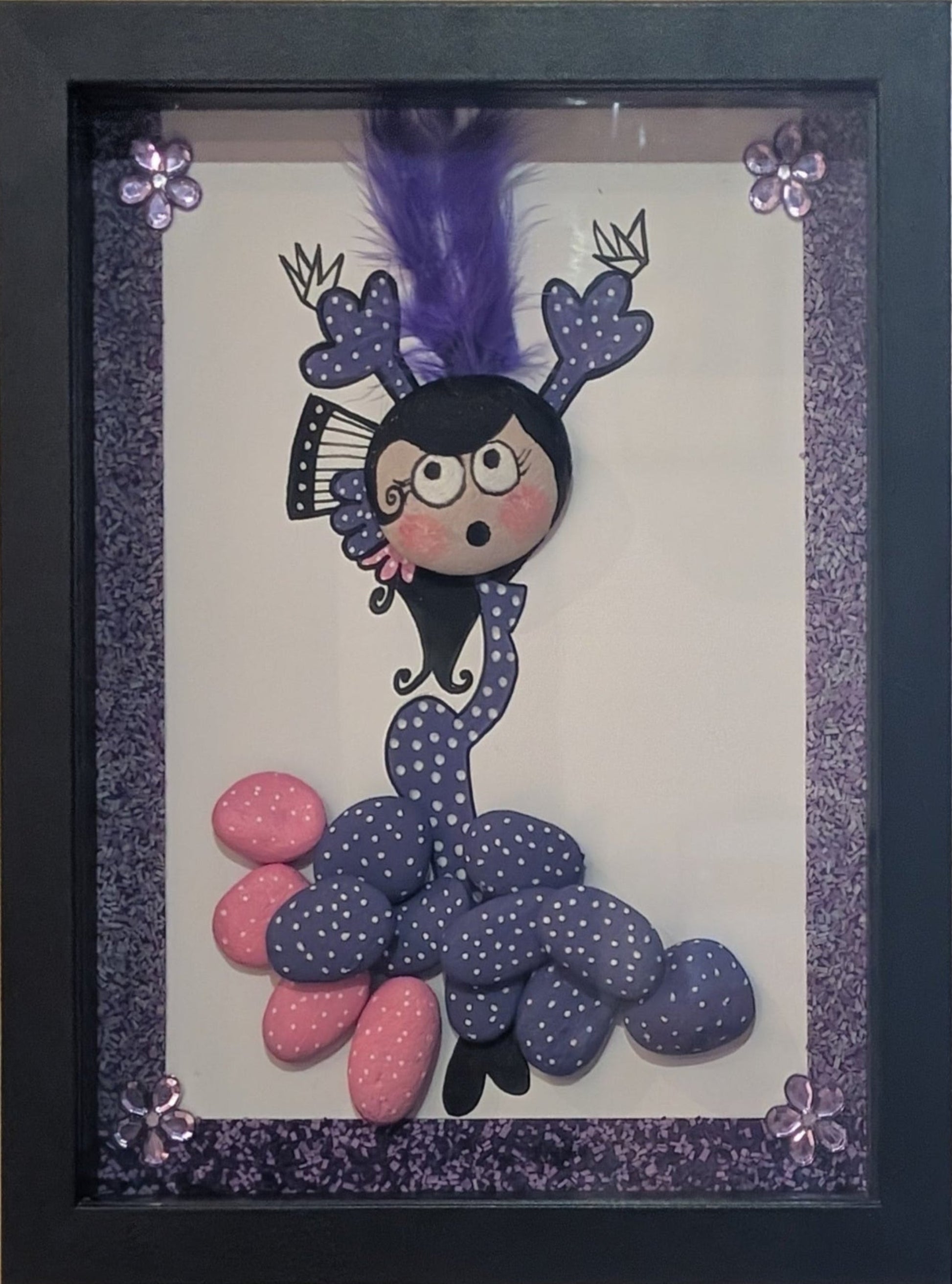 Framed pebble art of a flamenco dancer in motion, with vibrant pink and purple stones, symbolizing the energy, rhythm, and elegance of flamenco.