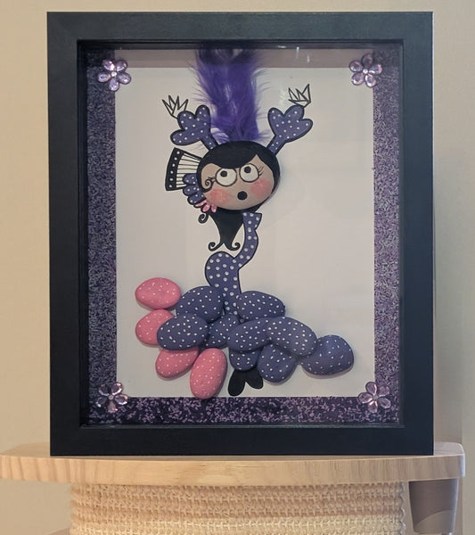 Framed pebble art of a flamenco dancer in motion, with vibrant pink and purple stones, symbolizing the energy, rhythm, and elegance of flamenco.